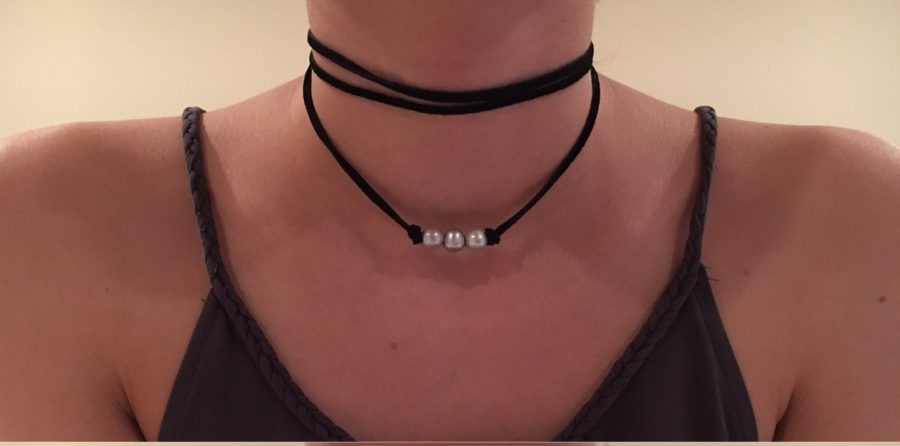 Marvin wears one of her handmade choker necklaces.