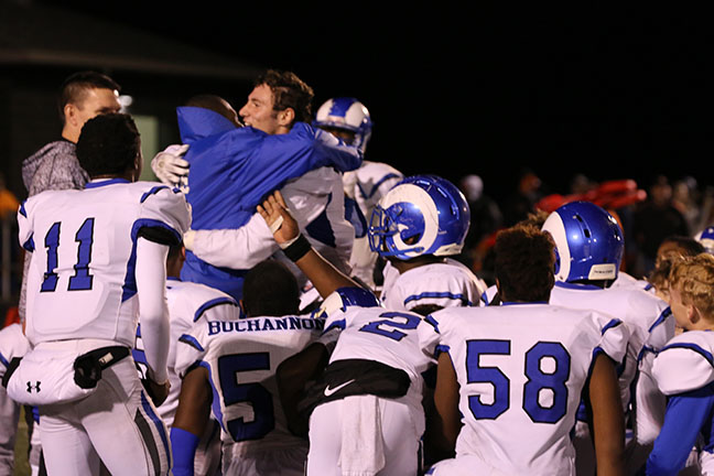 Chino Davis and Evan Mack hug after the Rams defeated Cape Girardeau Central 31-28.  Davis injured himself during the game and is out for the season. 