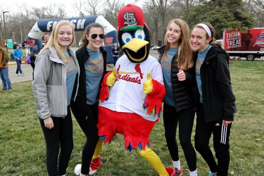 Students Julia Biest, Maggie Lochmoeller, Lindsay Goeler and Lila Bensky pose with Fredbird.