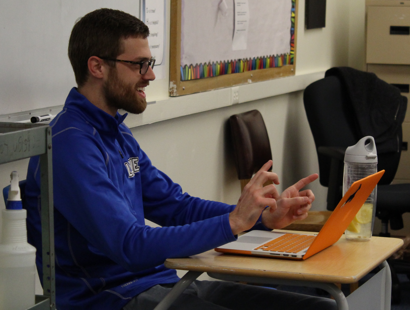 Jonah Krueger, the Quizbowl sponsor, reads questions from a set at practice.