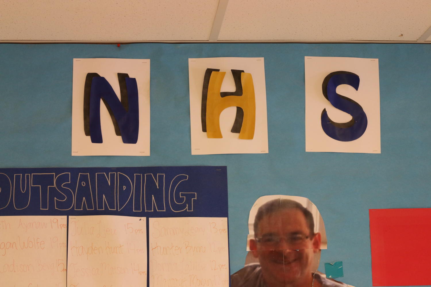 The National Honor Society board hangs outside of the cafeteria and displays the students who have volunteered the most.  