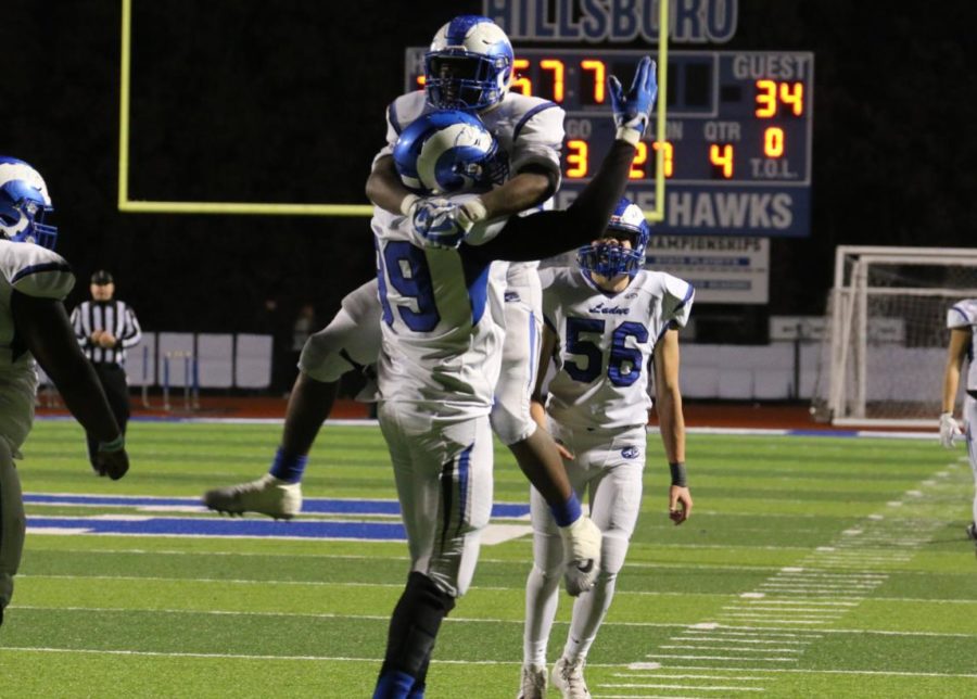 Senior BJ Buchannon celebrates with junior defensive end Moses Okpala. Okpala forced a fumble with 57 seconds remaining in the game to seal the 34-20 win. 