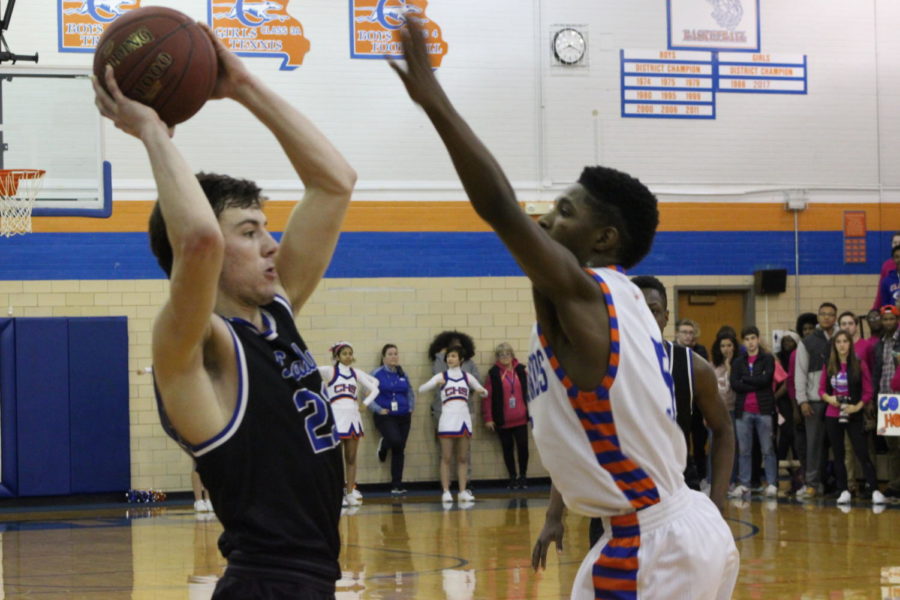 Ladue senior Trent Stiebler defends the ball from an opposing player on Clayton's team before taking a free throw. Ladue won the game with a score of 50-47. "Between shirt sales and the collection at halftime, the two schools raised almost $2000." STUCO organizer James Goldwasser said.