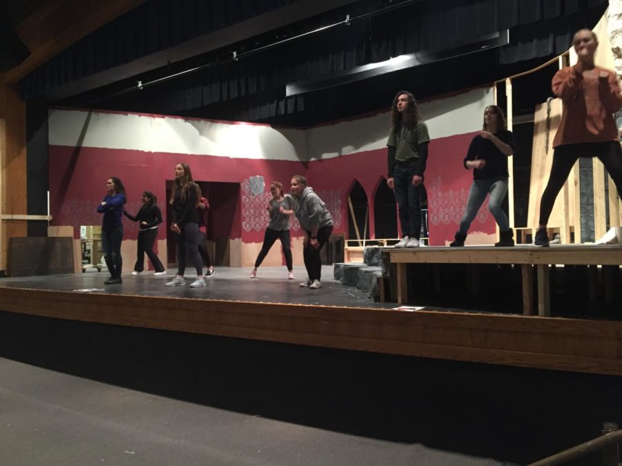 Getting ready to hit the stage, the cast of "The Addams Family" sings on the newly-built set. They open Feb. 22. "There are no deadline extensions or extra help we can get, all of us have to work really hard to get the show where it needs to be, but that's what makes it exciting," senior Katie Bohnert said.