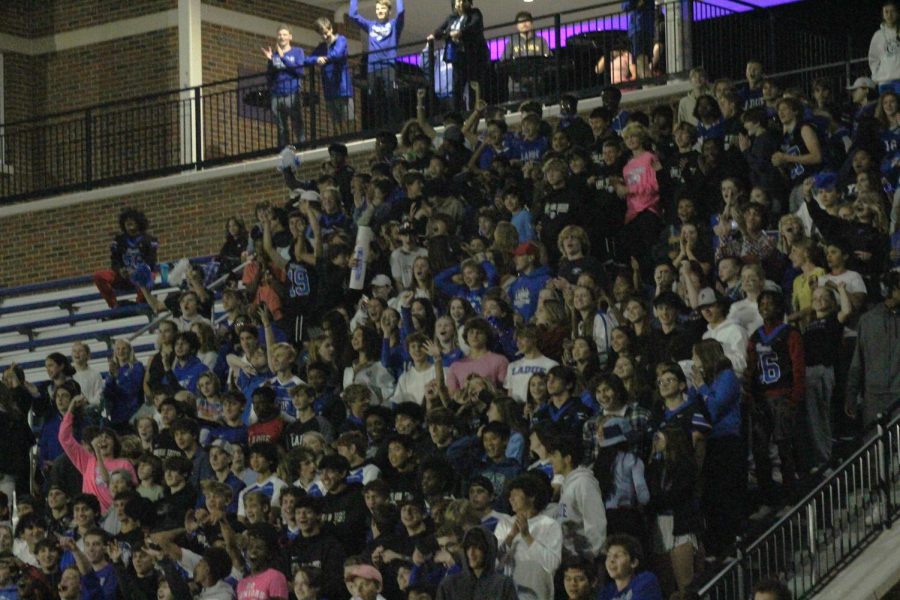 The student section at Blue and White Night on Oct. 12, 2022 cheers on Powderpuff players in a show of school spirit. Sophomore golfer and band member Audrey Goldman enjoyed Blue and White Night as a fun way to show school spirit. "I like how each fall sport is represented and I think it's fun for anyone who wants to go," Goldman said. 