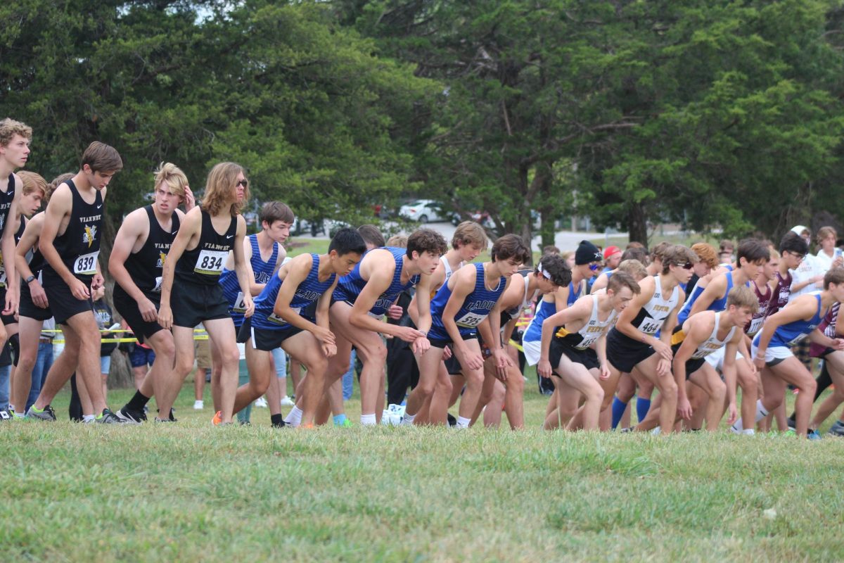 The varsity boys team lines up at the starting line.