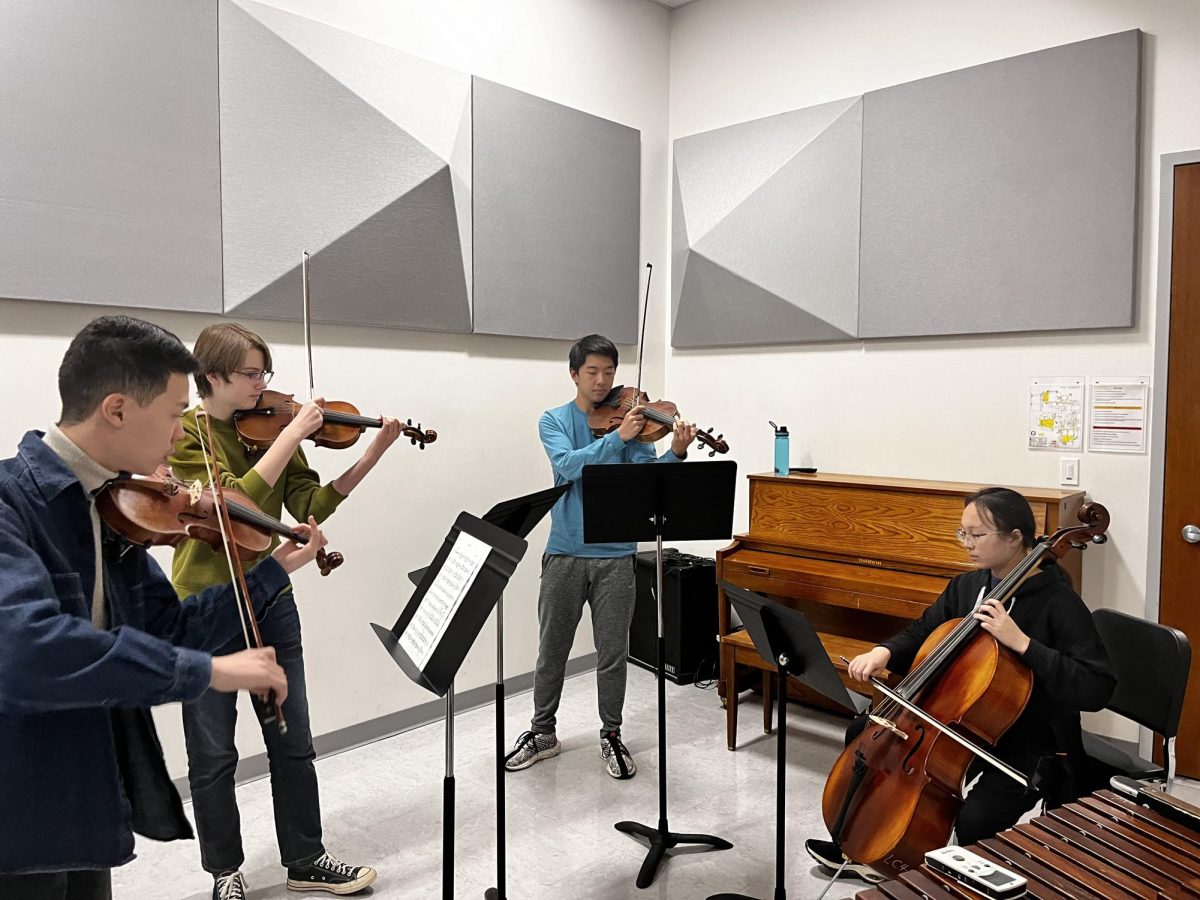 (From left to right) Adam Ye (11), Hayden Baker (10), Alex Farn (11) and Margaret Leung (11) rehearse chamber music together. The group was sight reading to get to know each other better as musicians. "It's just fun to play with others," Leung said. "Especially in full orchestras and chamber since playing solo doesn't have the same feeling [as] playing with another person."