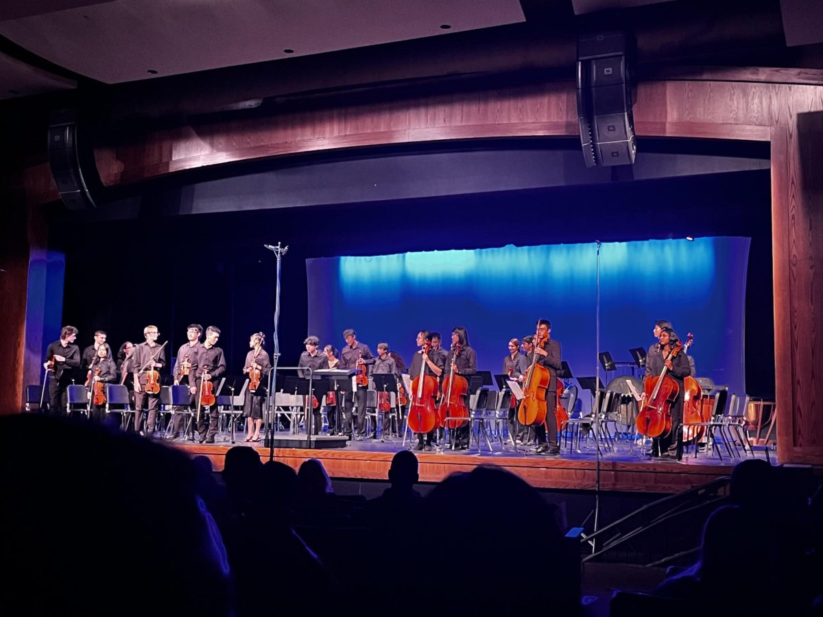 Ladue Chamber orchestra stands at the end of their concert. This was co-concertmaster Micky Chyu's (12) final fall concert. "This was my 14th concert at Ladue," Chyu said.