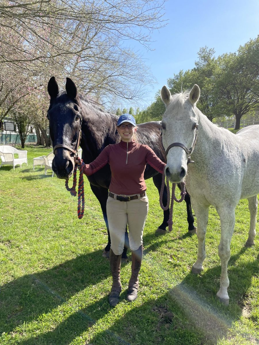 Jamie Gavril stands next to her two horses Tyler (left) and Rigel (right). Gavril's career in horseback riding began young, and she continues to ride today. "As an adult, [horseback riding] has become part of my lifestyle. And if the drive isn't more than 30 minutes, I go [to the stables] every day," Gavril said.