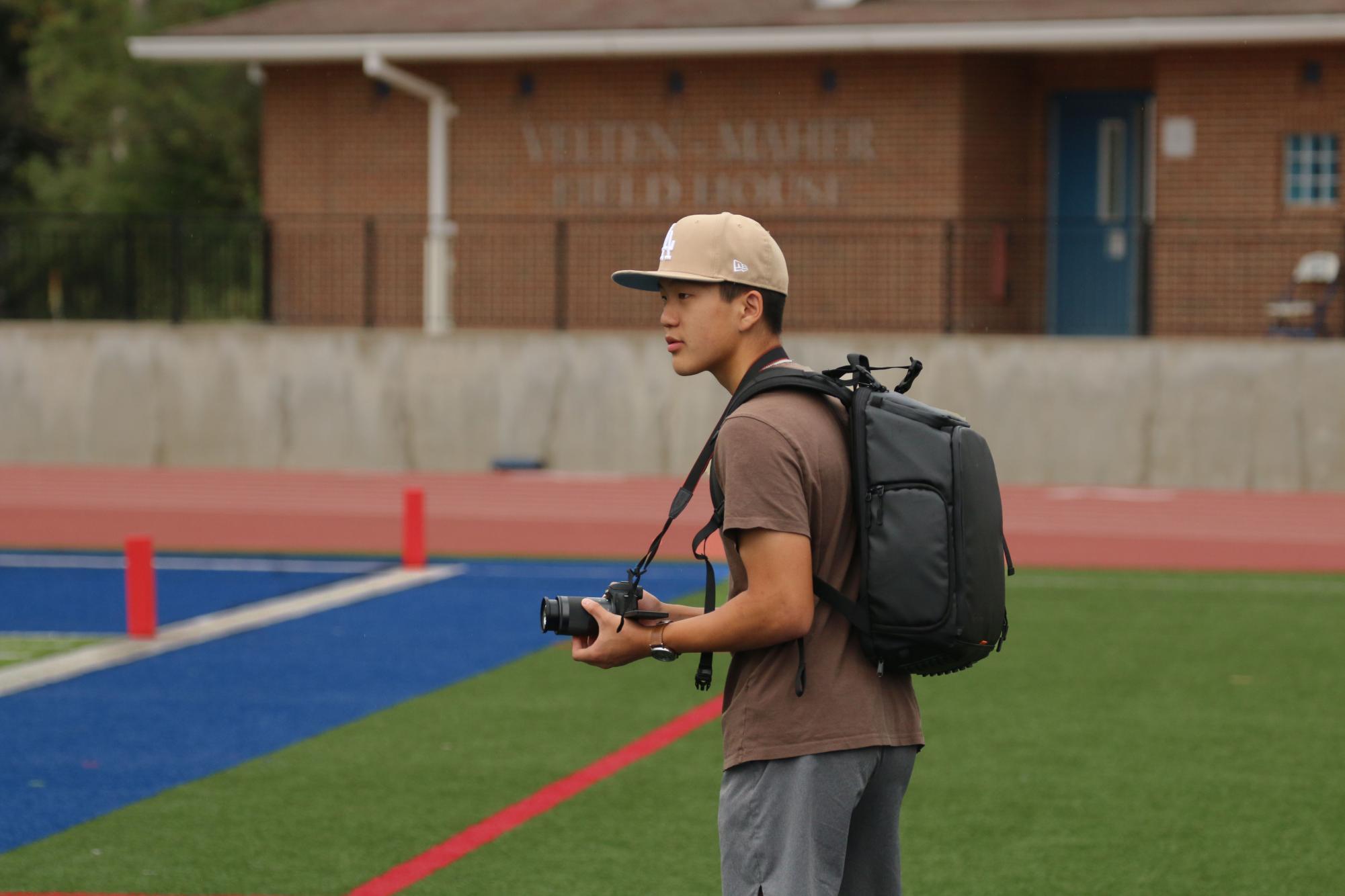  Junior Stephen Song films a video for Ladue’s varsity football team. He's been filming for about two years. He started filming on his phone, but transitioned into a professional camera. He believes that anyone can start videography, or anything else they want to do. “It's less about your equipment but more about what you can do and maximizing with what you have,” Song said.