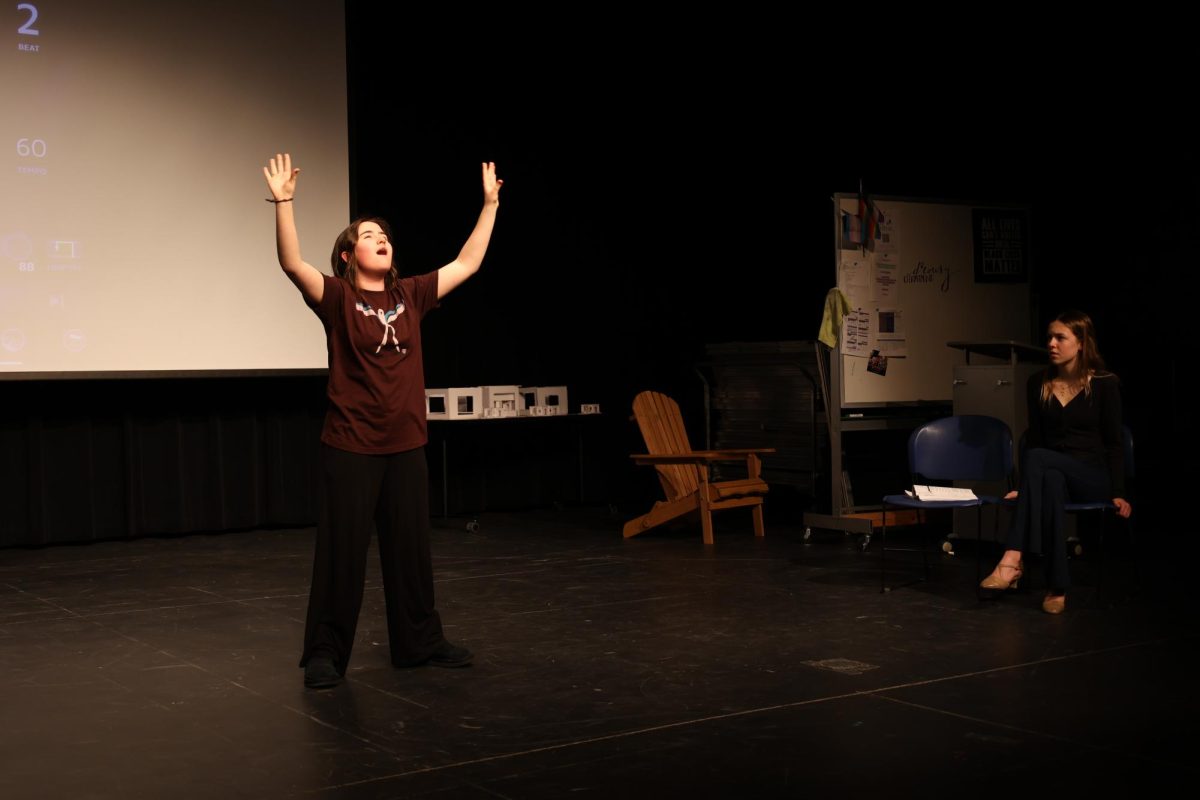 Lily Warenberg (12) throws her hands up as she acts out a scene during rehearsal. The musical is over two hours long. “This is one of my favorites that we’ve done this year,” Pinon-Dickey said.
