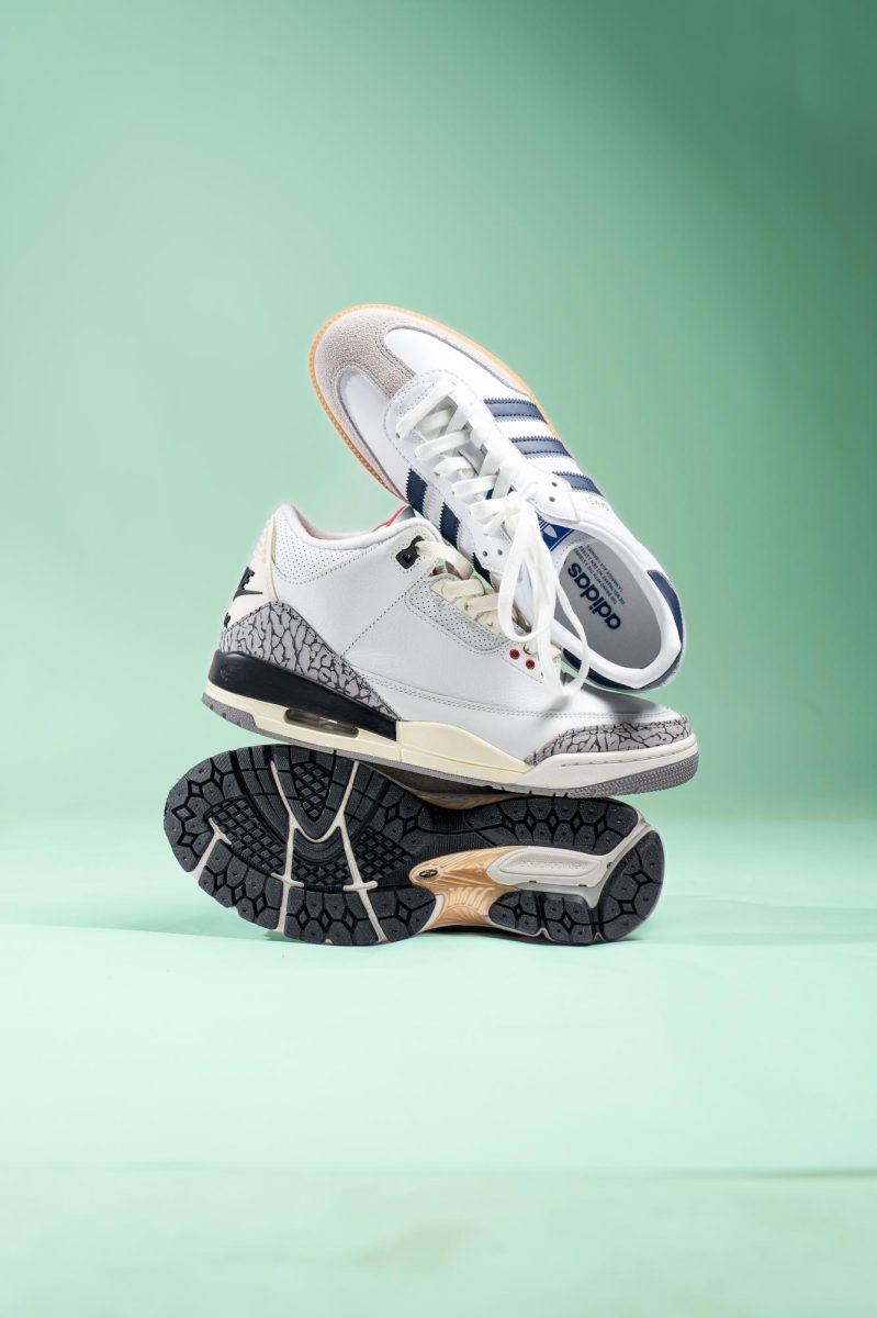 Justin Espinosa stands with his spring rotation of shoes in the studio March 13. Espinosa’s vast collection allows him to create seasonal shoe cycles that work with the rest of his clothing. “At any point I can put on the Clarks [Wallabees] that are a little bit more dressy or I could put on the Jordan 1 sneakers or the Jordan 3 sneakers or the Sambas and they’ll all go together with the outfit,” Espinosa said.