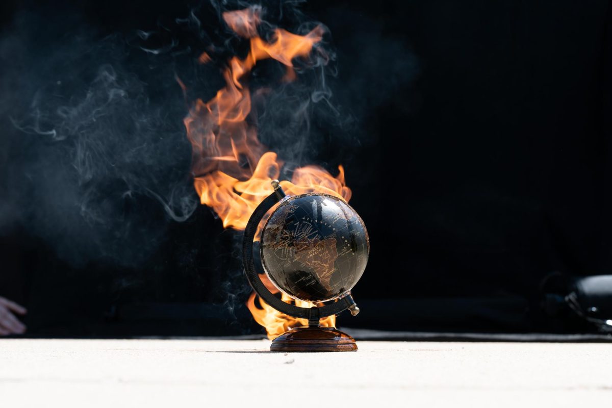 A globe on fire, symbolizing climate change's effects.