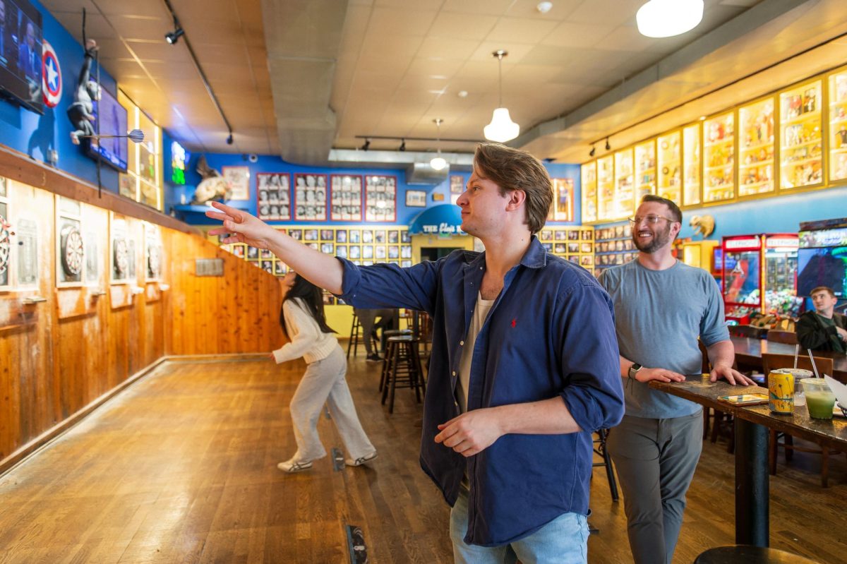 Eric Dazey and Grange Burton play darts at Blueberry Hill. It was Burton’s first time in the Delmar Loop, with Dazey bringing him to Blueberry Hill. “I really like [Blueberry Hill] just because you have the darts, you have different things in an environment that you can play in that’s very just chill [and relaxed],” Dazey said.