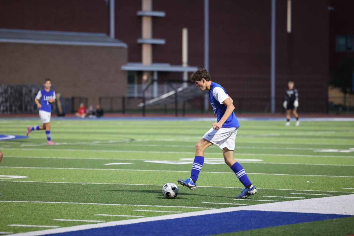 Defender Andy Schulte (12) plays under the lights at our stadium field. Tuesday Sept. 9, the boys soccer team played Oakville High School and won 3-0. "The game went exactly how we wanted to because we scored early, and we kept the pressure up," Schulte said.