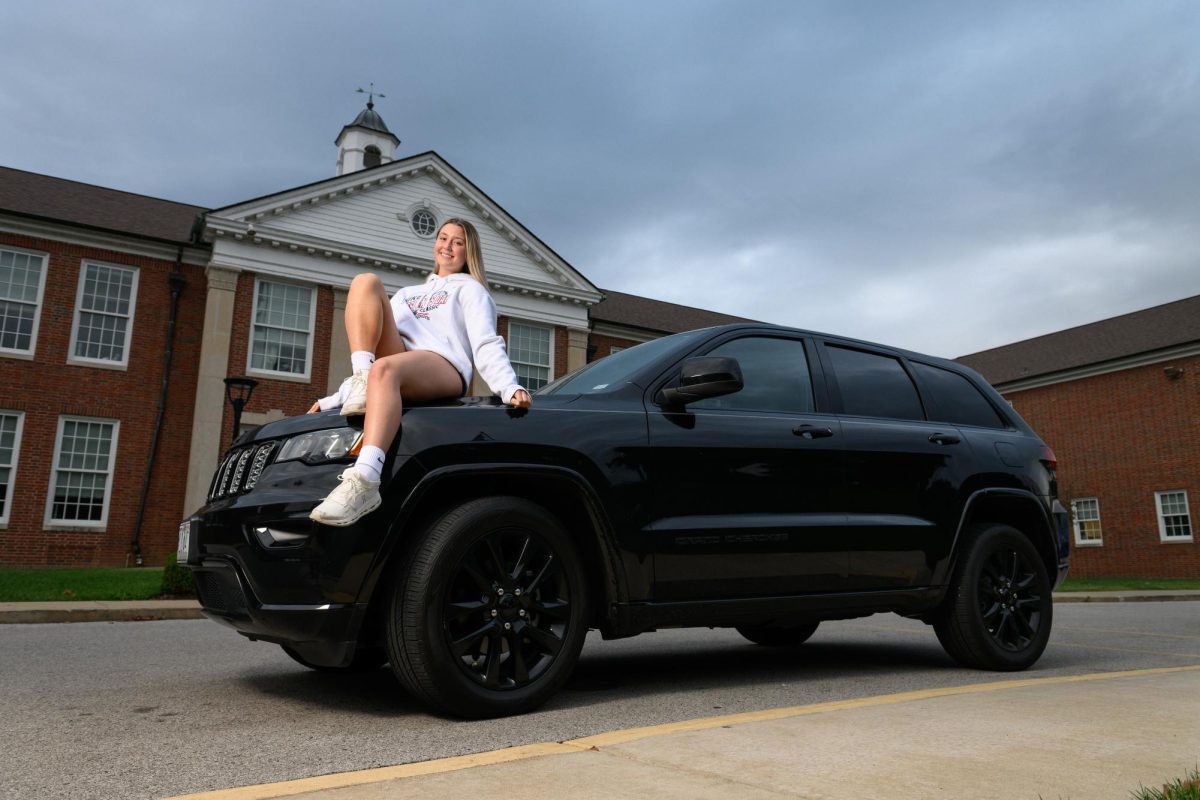 Sophia Kotowski (10) poses with her Jeep Grand Cherokee in front of the school Sept. 24. Kotowski began constructing her work schedule and managing her money to purchase her car at 13 years old. “I was so proud of myself,” said Kotowski.