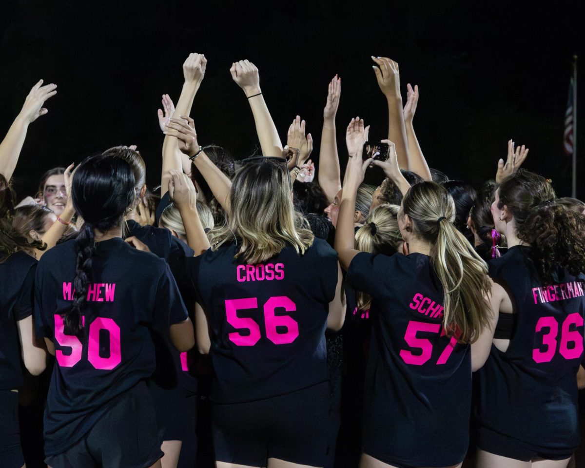 Students and staff gather together as the annual Powderpuff game commences Sept. 29. Seniors came out victorious over the juniors 24-0. "I was just happy to be with my friends," Kira Cornell (12) said. "It was fun and a good way to start homecoming week."