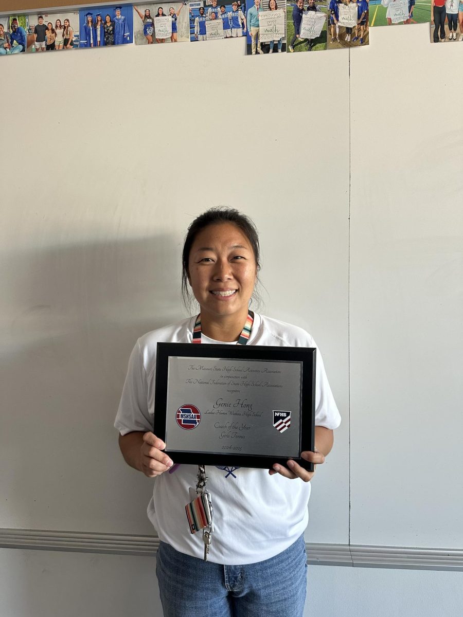 Genie Hong stands with her MSHSAA Girls Tennis Coach of the Year award. Hong coached the girls tennis team for only one year before receiving the award Sept. 11. "I love the camaraderie that [the team] builds throughout the season," Hong said. 