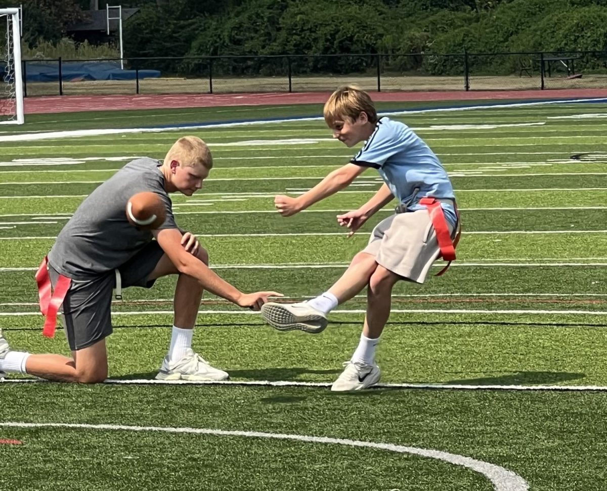 Freshman PE students wrap up their soccer and flag football unit. The class spent the past few weeks learning and playing soccer and football outside on turf field. "I thought [the football and soccer unit] was fun getting outside and hanging with my friends and getting exercise," Lou Shipley (9) said. 