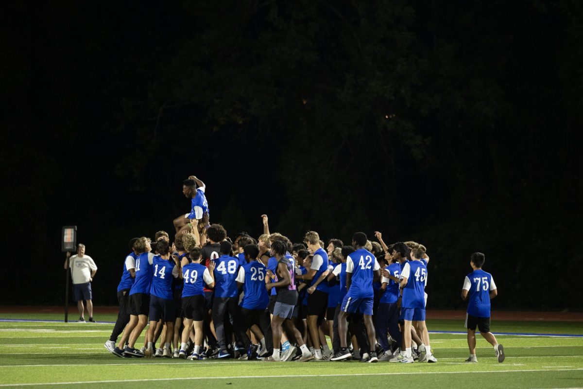 Juniors and seniors compete at the annual Powderpuff football game Sept. 29. Campbell Cross (12) cheered on the sidelines with the boys cheer team, The Squad. “Powderpuff was really fun this year, especially getting to cheer on the sidelines with the boys and rushing the field after the senior win,” Cross said.