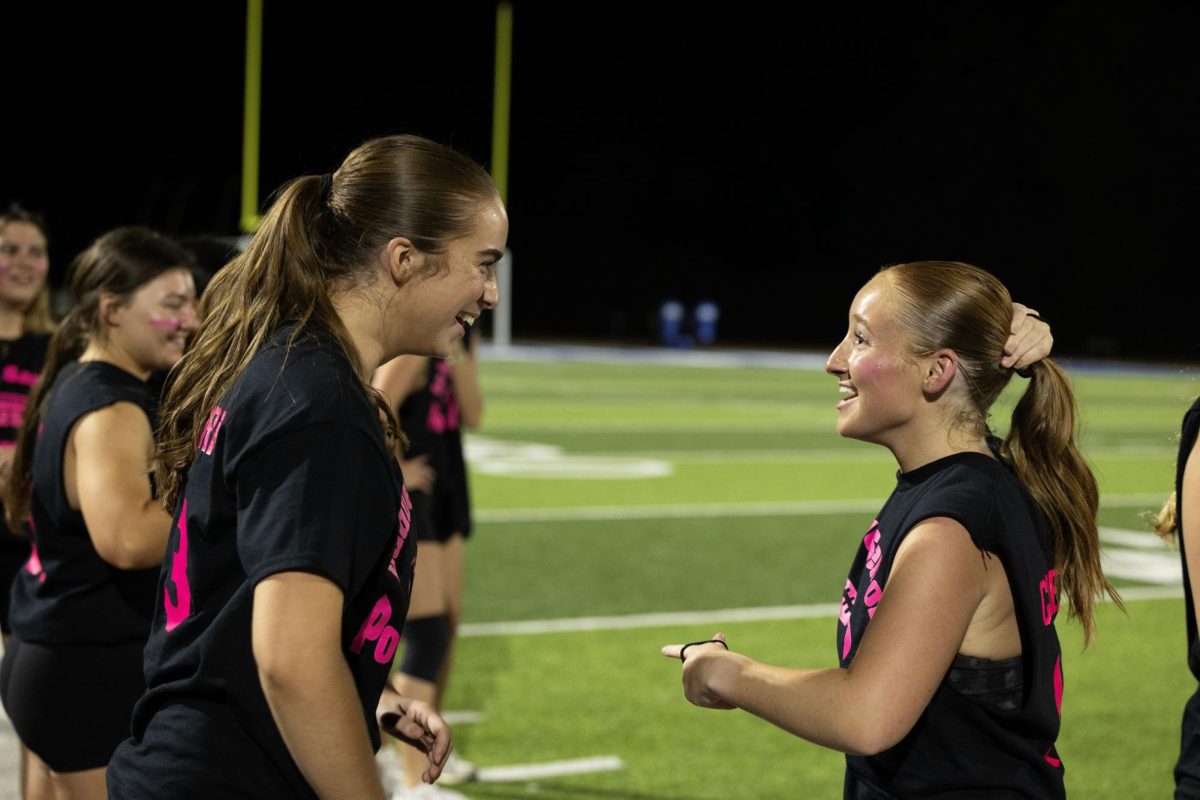 Juniors and seniors compete at the annual Powderpuff football game Sept. 29. Campbell Cross (12) cheered on the sidelines with the boys cheer team, The Squad. “Powderpuff was really fun this year, especially getting to cheer on the sidelines with the boys and rushing the field after the senior win,” Cross said.