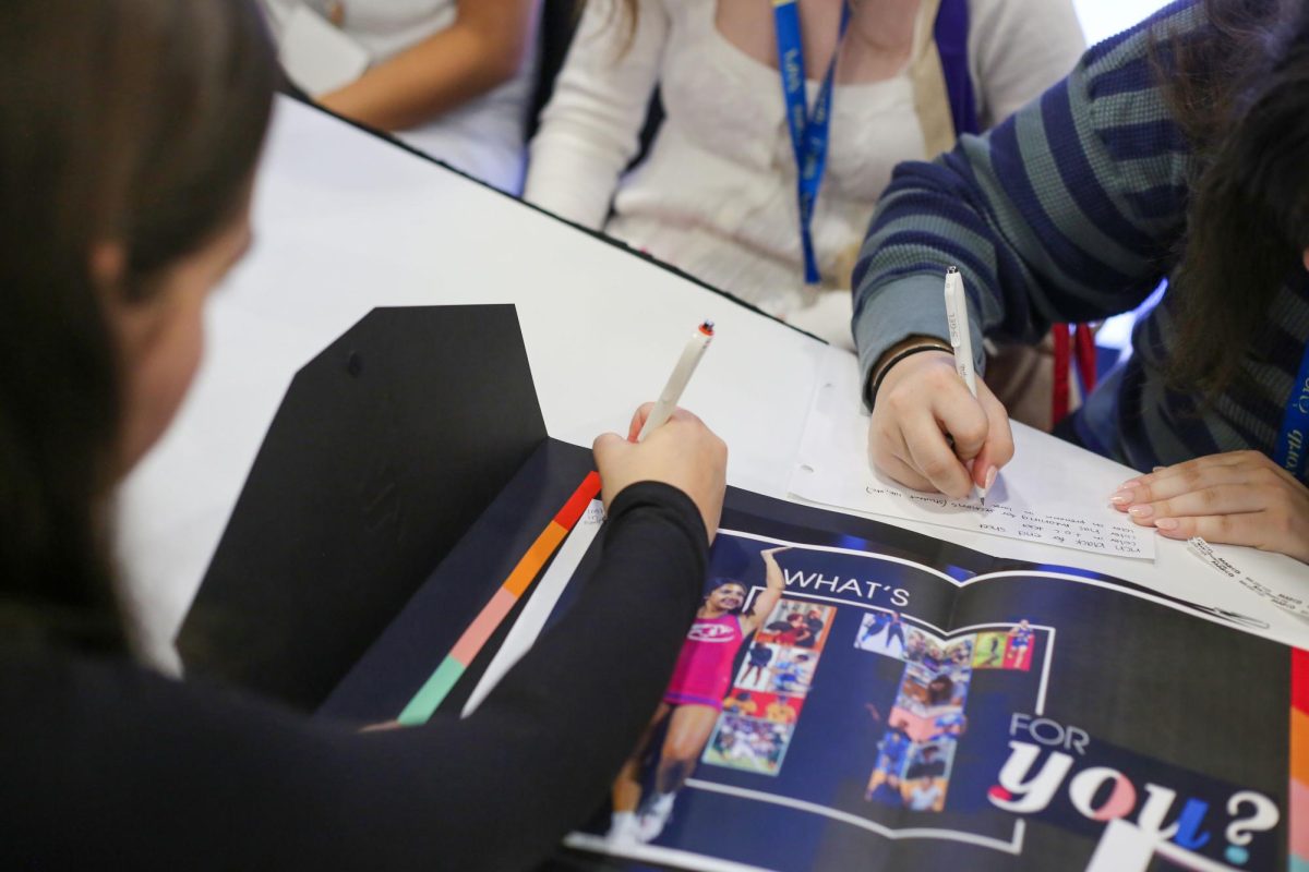 Yearbook editor in chief Ivana Todorova and copy editor Meagan Zimmerman meet with a representative from Varsity Yearbooks to discuss the 2026 Rambler. Todorova has spent three years on the yearbook staff, while this is Zimmerman's first year. 