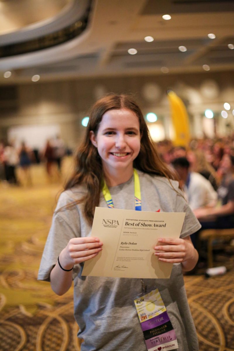 Senior Riley Dolan stands with her seventh place certificate for Yearbook Spread Design.  Dolan has been on yearbook staff for three years and won this award for her Softball page design in the 2025 Rambler. 