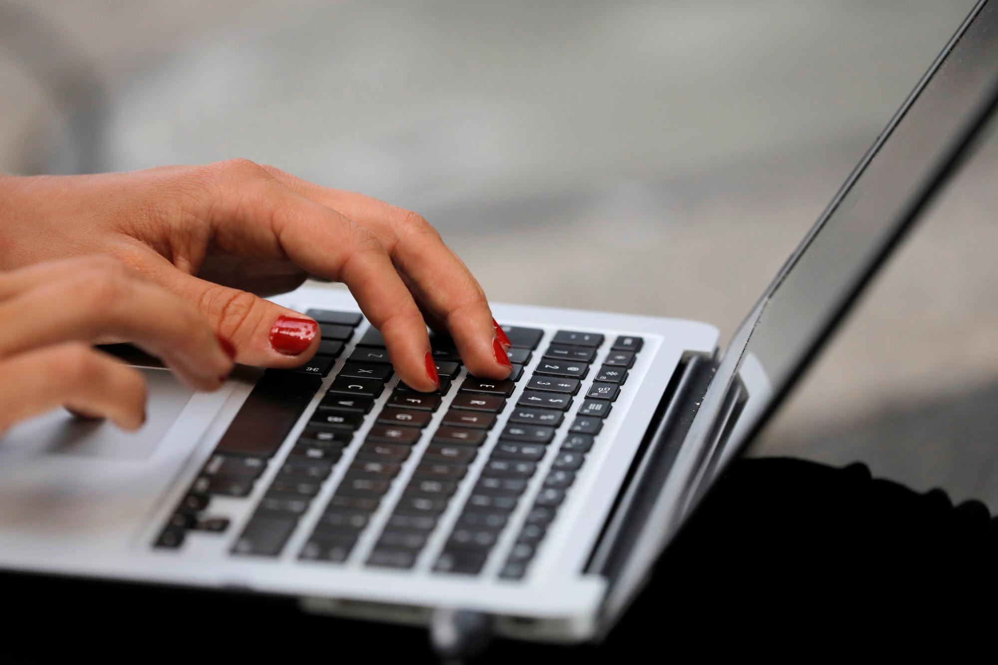 A person types on a laptop computer in Manhattan, New York City, U.S., September 11, 2020. REUTERS/Andrew Kelly