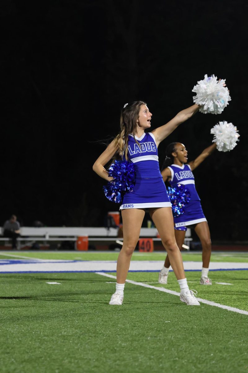 Amalia Frixone (11) cheers at the home football game Sept 19. The team played Hazelwood East High School and won 17-6. "I love performing and cheering on Ladue," Frixone said.