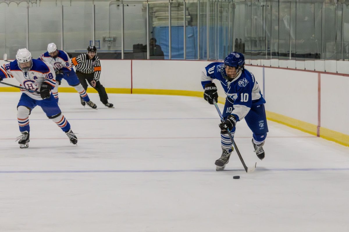 Gakhutishvili races across the ice in efforts to get the puck away from the opposing team. Ladue Boys Hockey played this game against Clayton 11/4. “Scoring the goal and celebrating my teammate was definitely the highlight of the game,” Gakhutishvili said. 