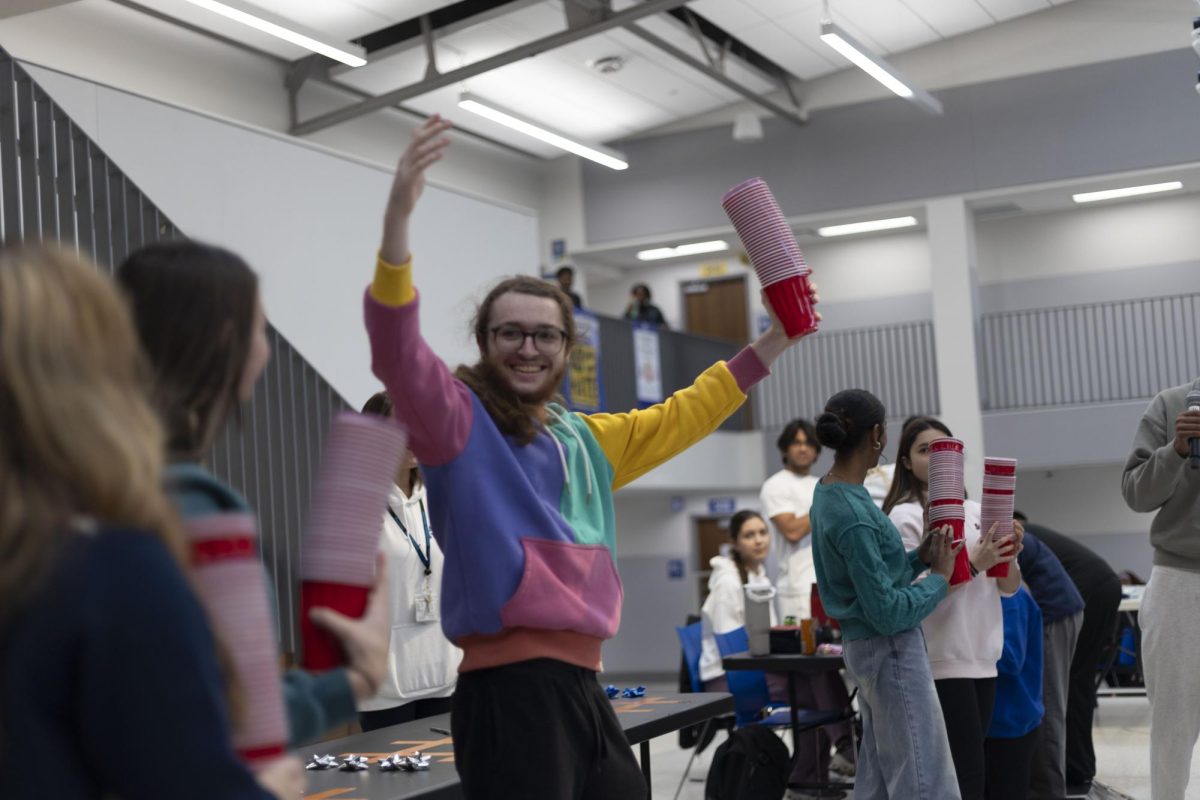 Students play minute to win it games in the cafeteria during lunch on Dec. 9. The games gave students a chance to take a break and have fun competition. "The games were for STUCO's spirit week, the themes were ski day and hat day," Austin Blake (11) said. 