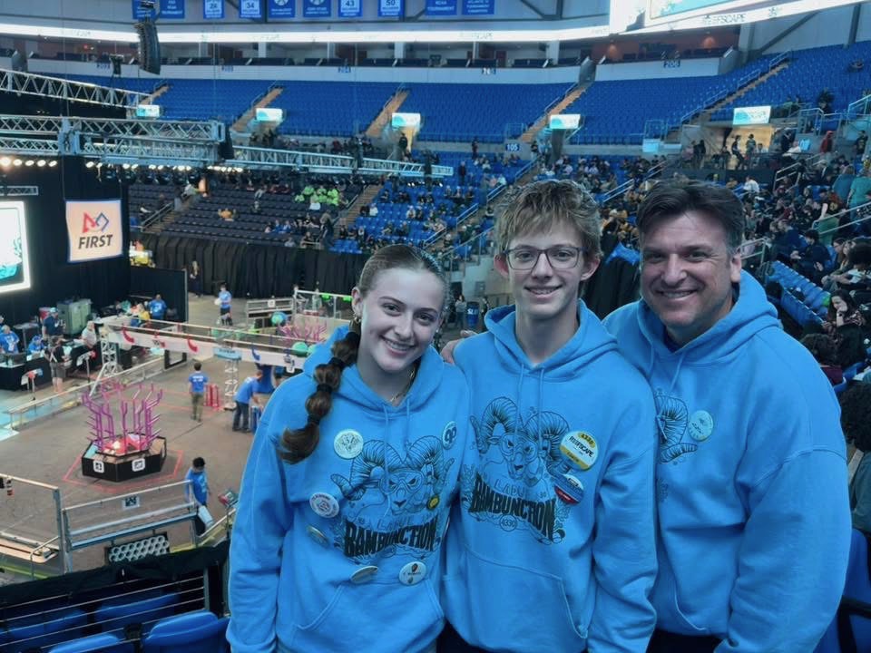 Posing next to her father and brother, Keys smiles at a robotics competition. Keys and her brother often practice coding their robot at home. “Over winter break, me and my brother built the fields [which] allowed us to practice our robot [at home],” Keys said.
