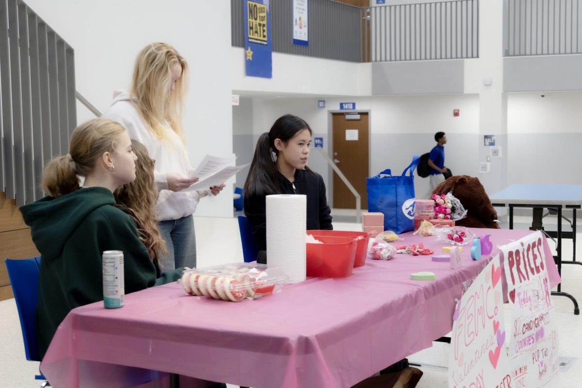 FemCo promotes their fundraiser during lunch Feb. 11. Members during different lunch periods took turns promoting the event. “First, we had to plan what we wanted to sell and [which] days,” Queena Xu (12) said. “We also had to have days to make posters and decorate the table. Our main focus was what to sell so we could buy it early.”