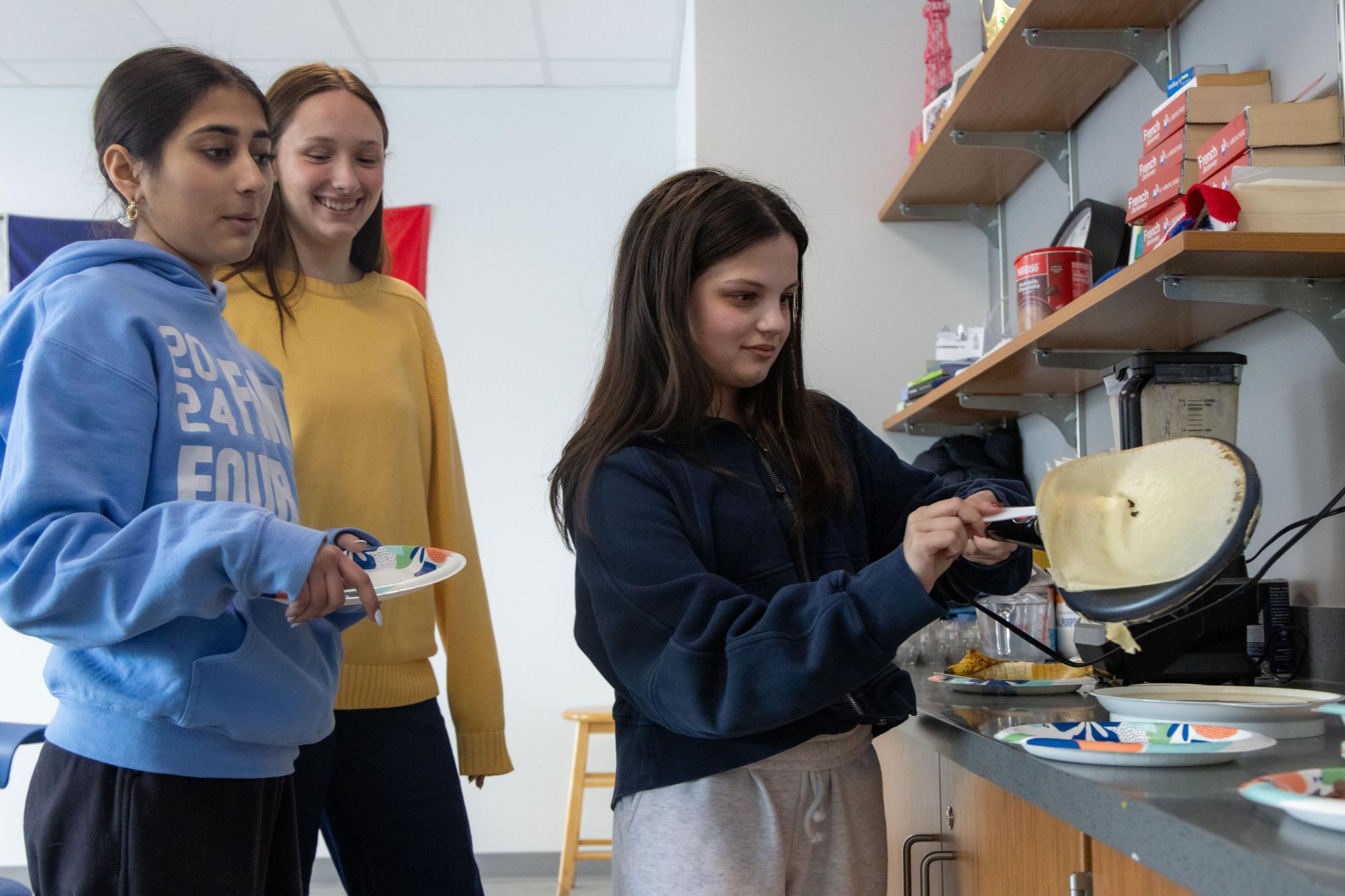 AP French students celebrate La Chandeleur by making crêpes in class