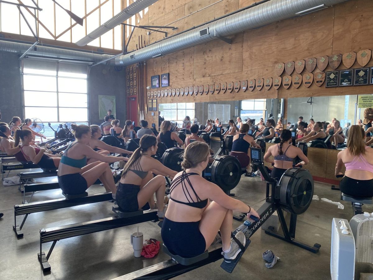 Members of the St. Louis Rowing Club girls varsity team row on ergometers. Students who try out for the team will learn how to properly take a stroke on the ergometers. “I recommend students try out for rowing because rowing is the ultimate team sport, and you get to grow and bond as a community,” Claire Williamson (11) said.