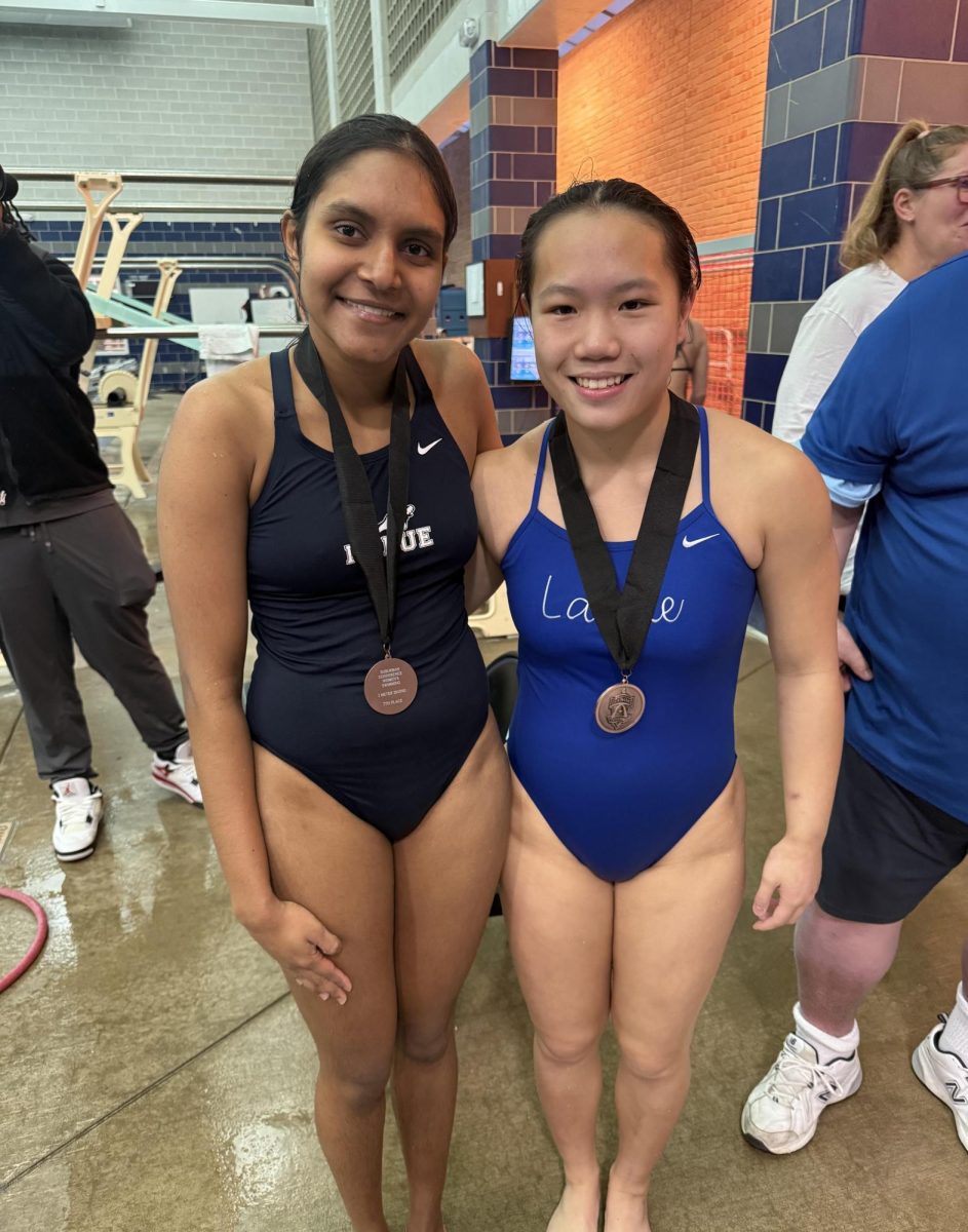 Ellen Widjaja and Niyumi Rajapaksha smile for a photo, wearing their medals earned at the conference meet Feb. 4. Widjaja placed 4th with a score of 314.25 points and Rajapaksha took 7th with a score of 259 points, both qualifying for districts. “I am very excited to learn new dives and do them at district,” Rajapaksha said.