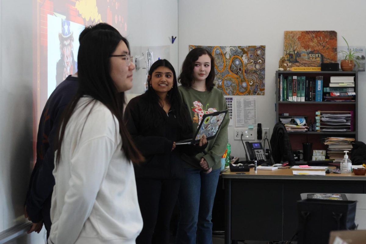 ACAG officers, including Queena Xu (12), discuss ideas with club members. Members signed up for various time slots during lunch to sell matcha to the student body. “We divided up the lunch spots on the sign up sheet and made sure we had enough people on each shift,” Xu said. 