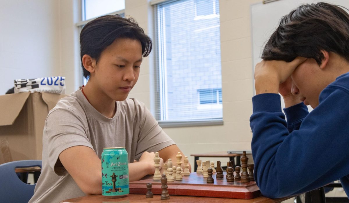 Pondering his next move, Alex Zhang (10) plays a practice game against teammate Newman Shen (11) to prepare for his next round. Zhang holds a USCF rating of 2265 and finished with a perfect four points on Board 1. “I enjoy getting to represent and score for my team,” Zhang said. “It really means a lot.”