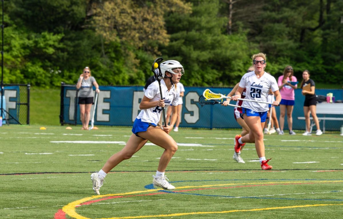 Vicky Derdoy (12) plays against MICDS at the Ladue West Campus Lower Field. The game took place April 29, 2025 and ended in a 12-10 victory for the Rams. “The energy [at the game] was super high because they were the number one seed at the time, and we were not expected to win, but we did,” Derdoy said. 