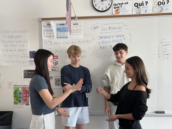 Team representatives Hotaru Murashita (11) and Regina Copeland (10) play rock paper scissors for the winning prize. The club hopes to continue to implement new meetings every year. “About a month ago, we pitched [the idea], and Madame Milford helped us obtain the croissants and jams,” Secretary Arlo Ziolkowski (11) said.  