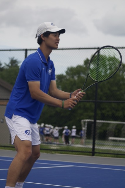 Ready at the net, Aiden Qian (12) waits for the right ball to poach off. The team had a close victory over Marquette April 29. "I've really enjoyed this season so far, and we're ready to head into post season tomorrow," Qian said. "This has been a great last season so far, and these memories will last a lifetime." 